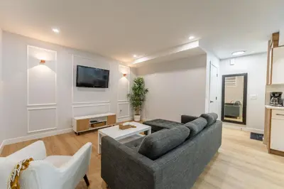 a living room with a couch and a tv at New 1 bdr basement apartment in Calgary