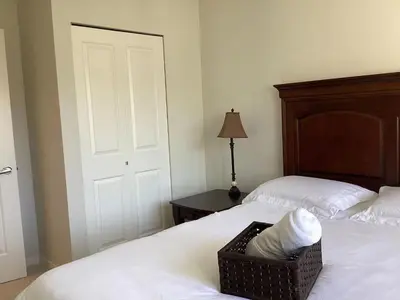 a bedroom with two beds and a basket on the bed at Vancouver Richmond Villa 33 in Richmond