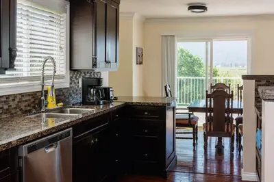 a kitchen with a sink and a table with a window at Serene 3BR Cabin on 8 Acre Farm in Mission City