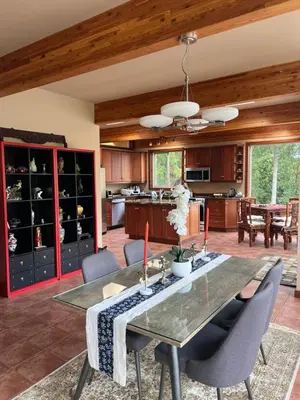 a kitchen and dining room with a table and chairs at Malahat Fairyland Cottage in Malahat