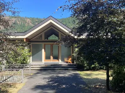 a house with a pathway leading to the front of it at Malahat Fairyland Cottage in Malahat