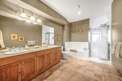 a large bathroom with two sinks and a shower at Treetops Ski Luxury Townhouse in Big White