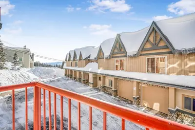 a row of buildings with snow on the ground at Treetops Ski Luxury Townhouse in Big White