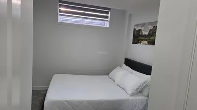 a small bedroom with a bed and a window at Modern 2BR near Hospital, YMCA, Stores in Calgary