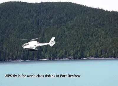 a white helicopter flying over a body of water at A Shack In The Woods in Port Renfrew