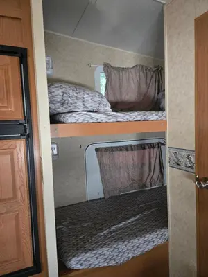 a small room with two beds in an rv at Family RV in a farm in Nanoose Bay