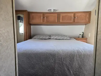 a bedroom with a bed in an rv at Family RV in a farm in Nanoose Bay