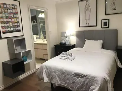 a bedroom with a white bed and a mirror at Vancouver Richmond Villa 32 in Richmond
