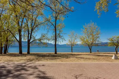 a park with trees and a body of water at Gyro Beach Vacations in Kelowna