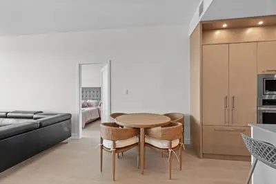 a kitchen and dining room with a table and chairs at Gyro Beach Vacations in Kelowna