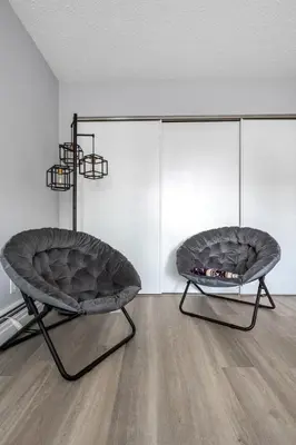 two chairs sitting in a room with a fireplace at YYC HiddenGem in Calgary