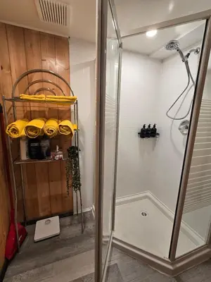 a shower with a glass door in a bathroom at The Hilltop in Whitehorse