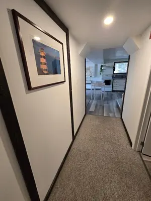 a hallway with a door and a picture on the wall at The Hilltop in Whitehorse