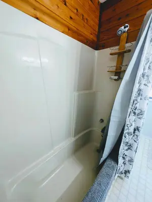 a bathroom with a tub and a shower curtain at Alert Bay, Spacious Executive Suite with Panoramic Ocean Views in Alert Bay
