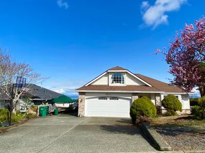a house with a white garage with a roof at Angie house in Nanaimo