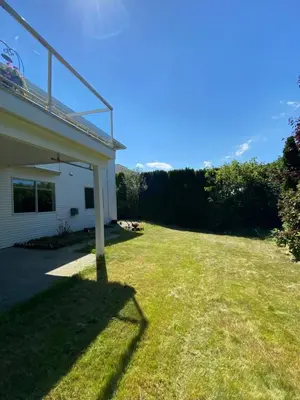 a grassy yard next to a house at Angie house in Nanaimo