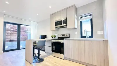 a kitchen with a counter and a chair in it at Vancouver Westside Villa 37 in Vancouver
