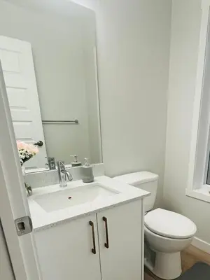 a bathroom with a white sink and a toilet at Cozy house with 4 Bedrooms 3 Full bath and 1 half bath in Calgary