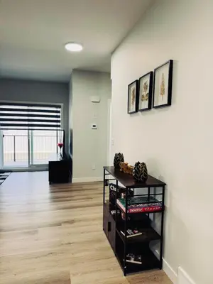 an empty living room with a shelf with shoes at Cozy house with 4 Bedrooms 3 Full bath and 1 half bath in Calgary