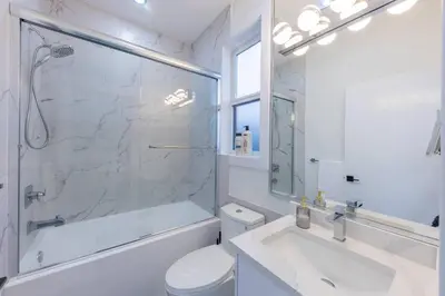 a bathroom with a shower and a toilet and a sink at Luxury Home in Victoria