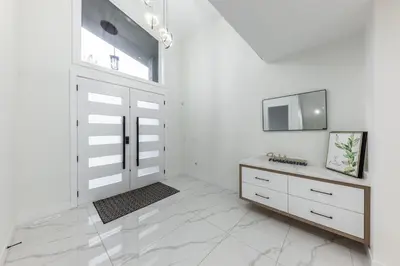 a white room with a door and a tv at Luxury Home in Victoria