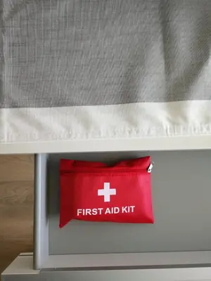a red first aid kit sitting under a bed at New condo Great amenities Near Skytrain in Coquitlam