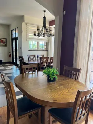 a dining room with a wooden table and chairs at A Gorgeous Mansion for Jasper Vacation in Hinton