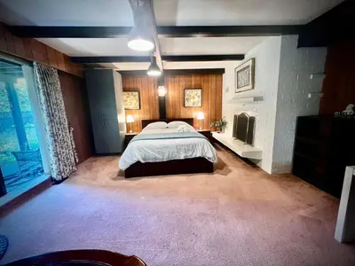 a large bedroom with a bed and a fireplace at Luxury Space close to UBC in Vancouver