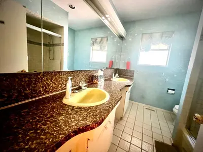 a bathroom with two sinks and a large mirror at Luxury Space close to UBC in Vancouver
