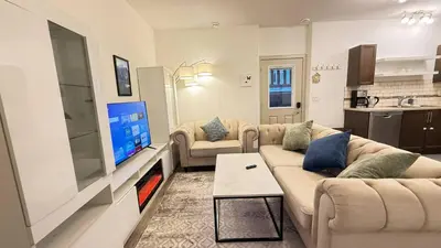 a living room with two couches and a flat screen tv at Red Deer Stay- 2BR Private Suite in Red Deer