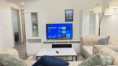 a living room with a large flat screen tv at Red Deer Stay- 2BR Private Suite in Red Deer