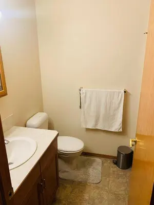 a bathroom with a white toilet and a sink at Master Bedroom with attached bathroom in Airdrie