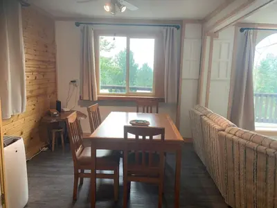 a dining room with a wooden table and chairs at Our little heaven Entire house 5 min south of town in Golden
