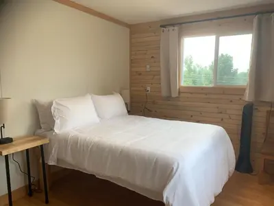 a bedroom with a white bed and a window at Our little heaven Entire house 5 min south of town in Golden