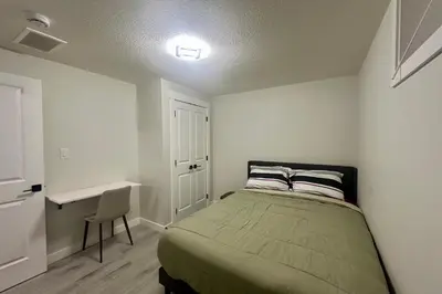 a small bedroom with a bed and a desk at Cozy 2BR Retreat - 10 Mins to WEM - Free Parking & WiFi in Edmonton