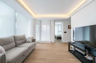 a living room with a couch and a flat screen tv at Urban Retreat 2BR Condo with Stunning City View in Vancouver
