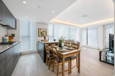 a kitchen and dining room with a table and chairs at Urban Retreat 2BR Condo with Stunning City View in Vancouver