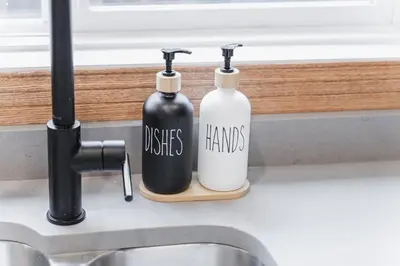 two bottles sitting on a counter next to a sink at Chic Garden Suite Hideaway 2Bedroom Games Room in Edmonton