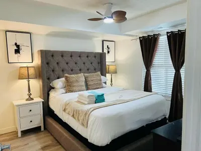 a bedroom with a large bed with a ceiling fan at Mordern 2BedRoom Downtown Apt with Free Parking & Wifi in Edmonton