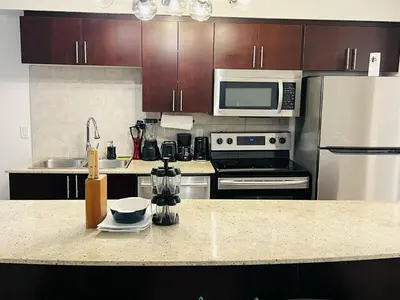 a kitchen with stainless steel appliances and a counter top at Mordern 2BedRoom Downtown Apt with Free Parking & Wifi in Edmonton