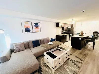 a living room with a couch and a table at Mordern 2BedRoom Downtown Apt with Free Parking & Wifi in Edmonton
