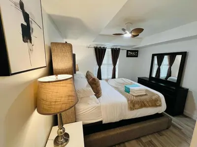 a small bedroom with a bed and a lamp at Mordern 2BedRoom Downtown Apt with Free Parking & Wifi in Edmonton