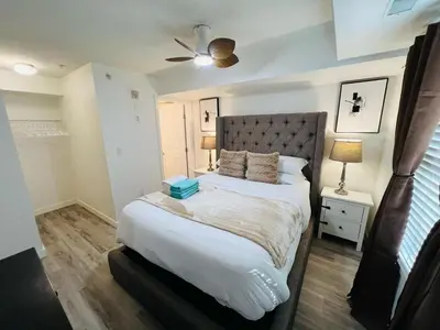 a bedroom with a bed and a ceiling fan at Mordern 2BedRoom Downtown Apt with Free Parking & Wifi in Edmonton