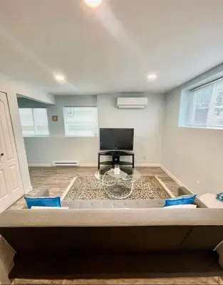 a living room with a couch and a table at Holiday Home in Coquitlam