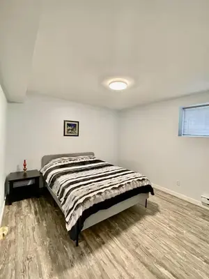 a bedroom with a bed in a white room at Holiday Home in Coquitlam