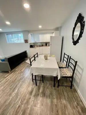 a dining room with a table and chairs and a kitchen at Holiday Home in Coquitlam