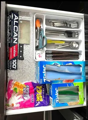 a drawer filled with utensils and other items at European-American Style Suite in Coquitlam