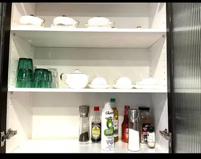 an open refrigerator filled with dishes and other items at European-American Style Suite in Coquitlam