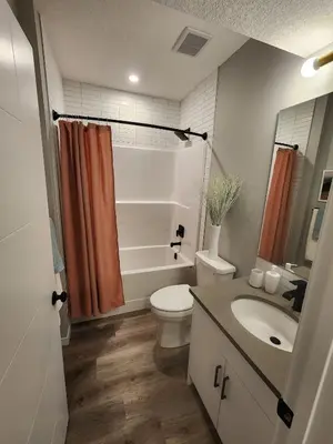 a bathroom with a toilet and a sink at Brand New Modern 2 Bedroom Basement Suite in Calgary