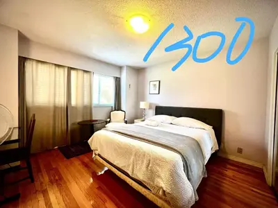 a bedroom with a bed with a sign on the wall at Cozy and spacious room near UBC-2 in Vancouver
